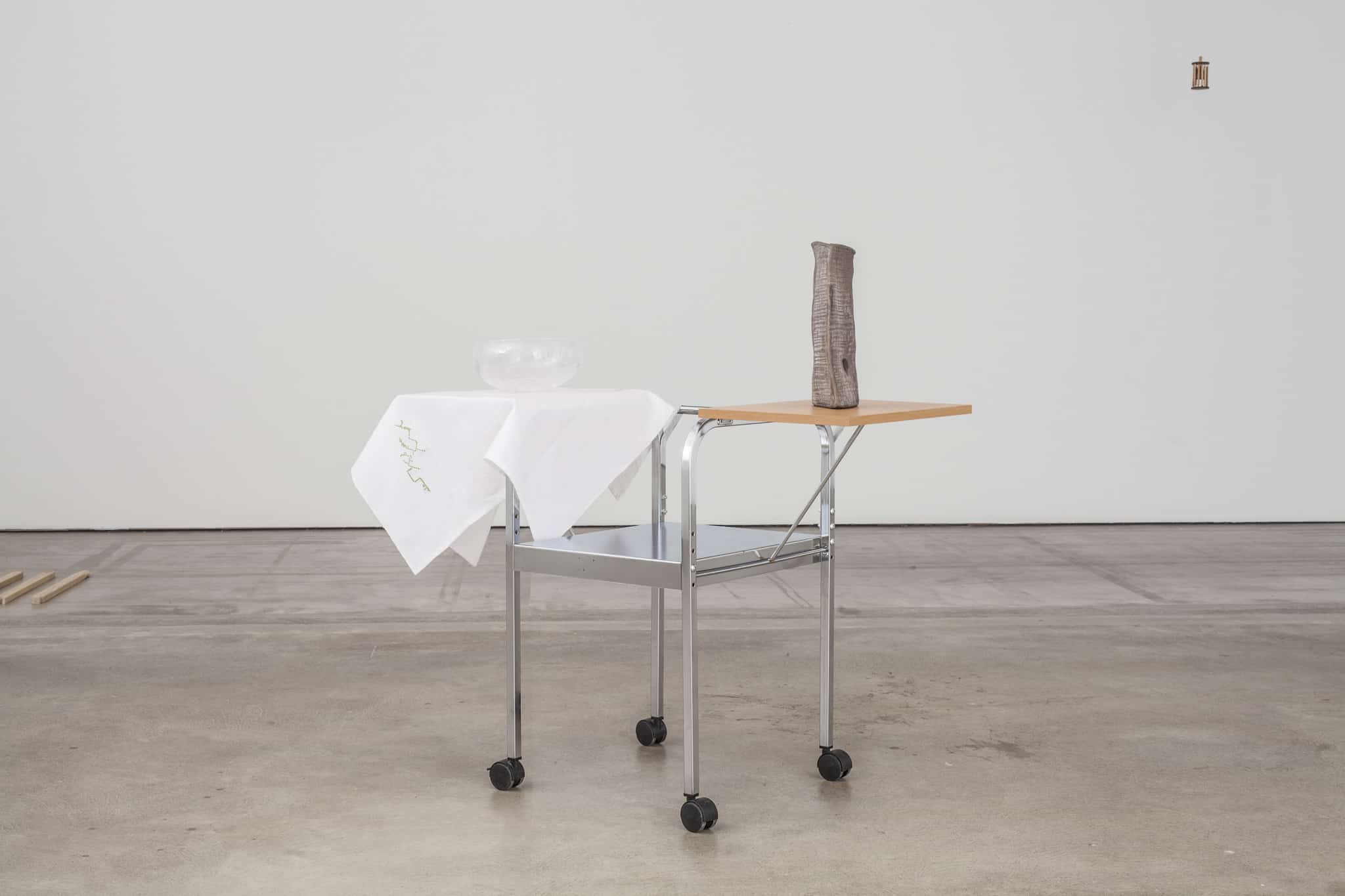 Cotton tablecloth by Ekaterini & Marietta hosting a glass bowl by Joonas Laakso, ceramic object by Normunds Langis